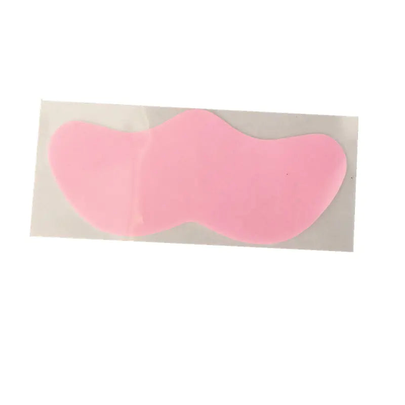 Pink eye mask on a beige background