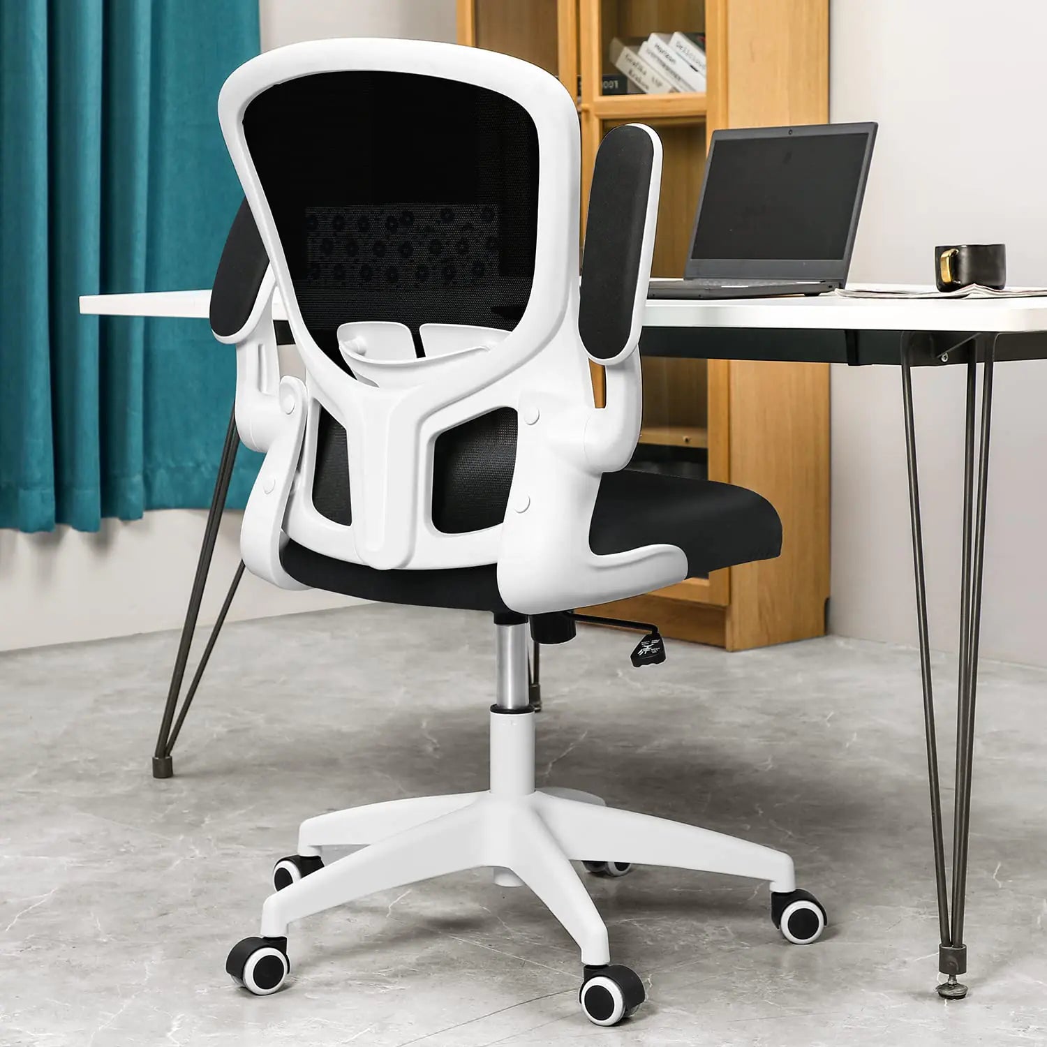 White office chair with black mesh backrest in a home office setting.