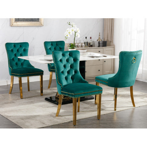 Teal velvet chairs with gold accents around a dining table in a modern kitchen.
