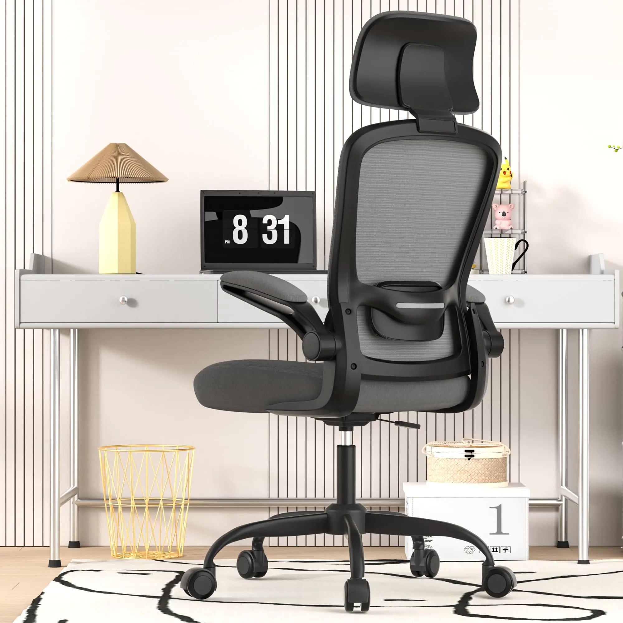 Black office chair in a room with a desk and decor items.
