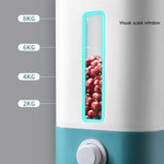 Close-up of a white-and-teal food dispenser with a narrow transparent “visual scale window” showing red beans inside, alongside labeled weight marks at 2 kg, 4 kg, 6 kg, and 8 kg.