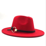 Red wide-brim felt hat with a black band and gold ring detail, photographed on a white background.