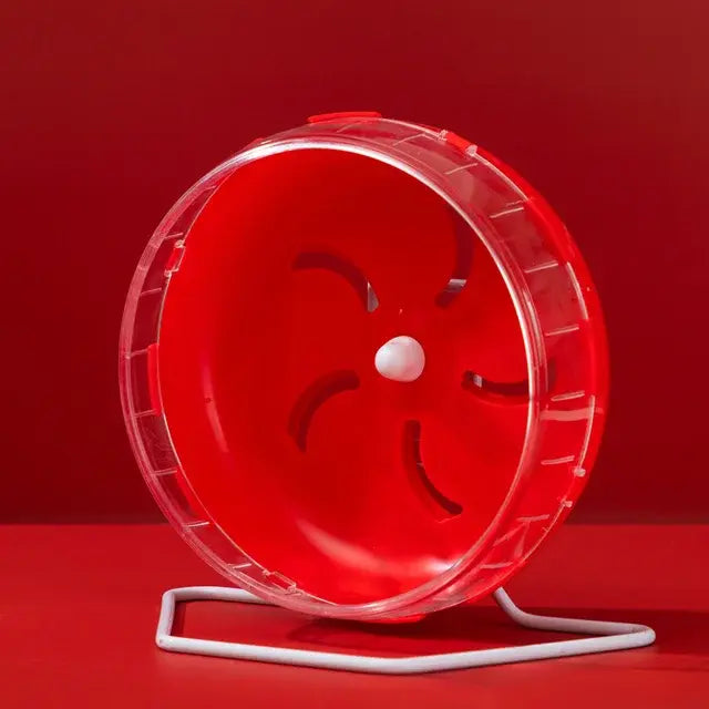 Red plastic hamster exercise wheel with a clear rim, mounted on a white metal stand against a red background.