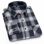 A neatly folded men's flannel shirt featuring a classic black, white, and gray plaid pattern. The shirt has a structured button-down collar, black buttons, and a single chest pocket. The soft flannel fabric gives it a warm and comfortable appearance, making it ideal for casual and outdoor wear. The monochrome color scheme adds a stylish and versatile touch, suitable for various occasions.