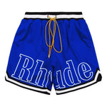 These Rhude shorts feature a bold and stylish design, perfect for streetwear and casual fashion. The elastic waistband with black-and-white stripe detailing and extra-long yellow drawstrings add a signature touch, making them both functional and fashionable. The sporty aesthetic is enhanced by the sleek trim along the hem, making them a great choice for everyday wear or athleisure outfits.