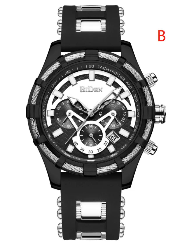 Black men’s chronograph wristwatch with a black rubber strap, silver and white dial accents, multiple subdials, and a tachymeter bezel, shown on a white background with a red “B.”