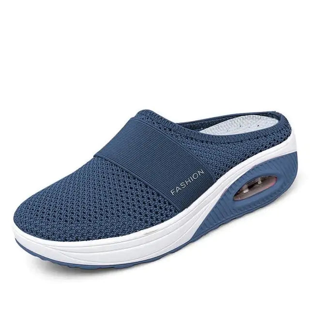 A single slip-on mesh sneaker with a white sole and air-cushion heel, featuring a breathable upper, an elastic band across the top for support, and the word “FASHION” printed on the side.