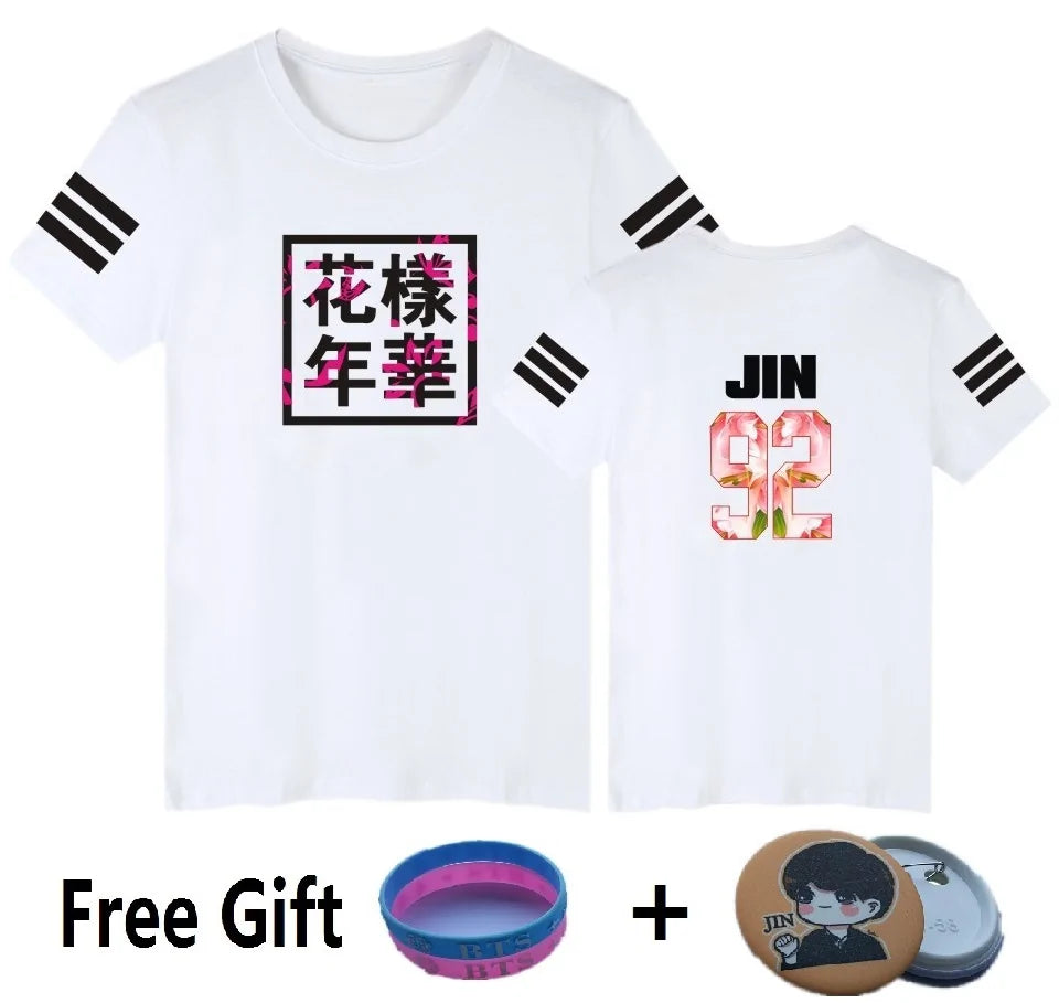White graphic T-shirt with black sleeve stripes, floral text print on the front and “JIN 92” print on the back, shown with free gift accessories.