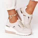 A pair of stylish black mesh sneakers worn with jeans. The shoes feature colorful embroidered details including a red and yellow daisy on the side and multicolored accents (red, blue, yellow) on the sole. The tongue displays a purple and red logo with the word "FASHION." The sneakers have a sleek, breathable design and a casual, trendy aesthetic