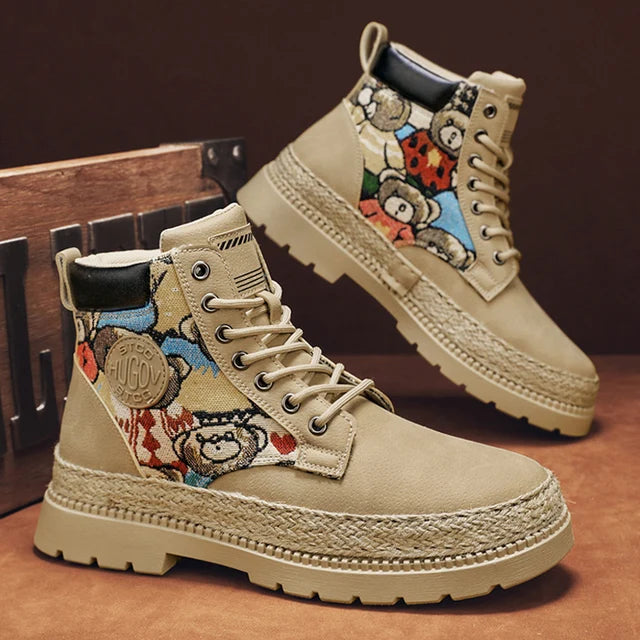 A pair of tan high-top boots with a thick jute-wrapped sole and colorful teddy bear patchwork fabric on the sides. The boots have a rugged design with metal eyelets and a branded patch on the side, displayed against a warm brown background.
