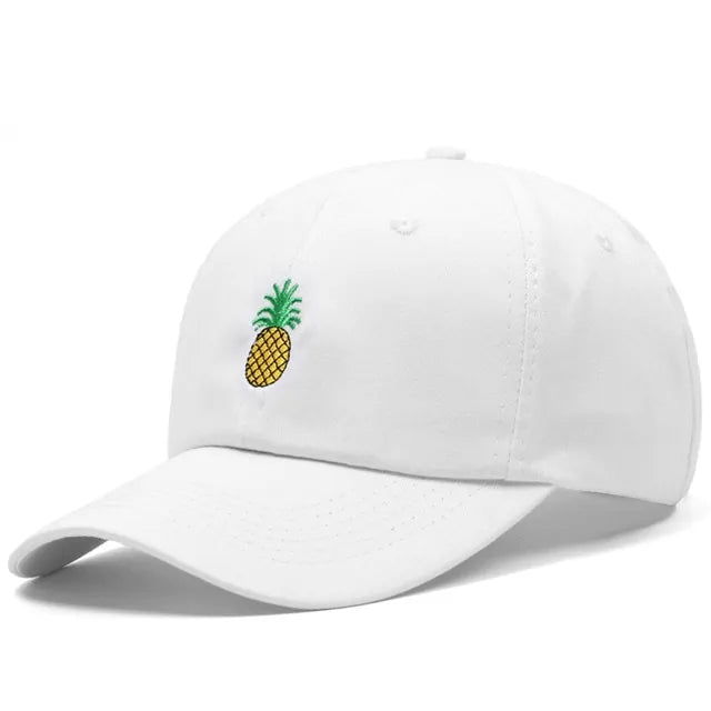 A white baseball cap with an embroidered yellow pineapple design on the front.