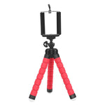 Small tabletop tripod with red foam legs and a black adjustable phone holder mount, shown on a white background.
