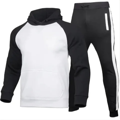 A stylish two-piece men's tracksuit. The set includes a hooded sweatshirt with a kangaroo pocket and long gray sleeves, along with matching jogger pants that have a drawstring waist and gray side panels with zippered pockets. The design offers a sporty yet casual look, ideal for workouts or everyday wear.