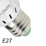 Close-up of an E27 light bulb socket showing the metal base and white top with a logo.