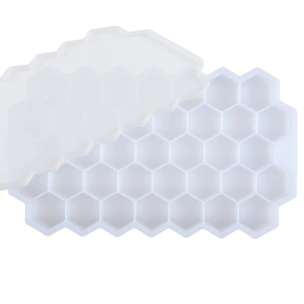White silicone ice cube tray with a honeycomb pattern of hexagonal compartments, shown on a white background.