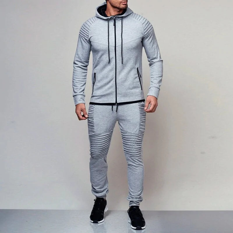 Grey men’s hooded tracksuit with zip jacket, joggers and ribbed panel details.

