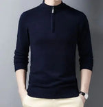 A stylish black slim-fit sweater with a quarter-zip collar, worn by a male model against a neutral gray background. The sweater has a ribbed hem and cuffs, giving it a sleek and fitted appearance. The model is also wearing light-colored trousers and a silver wristwatch, adding a touch of sophistication to the outfit.