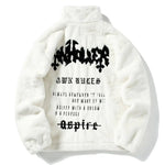 White fluffy fleece jacket with black graphic print.
