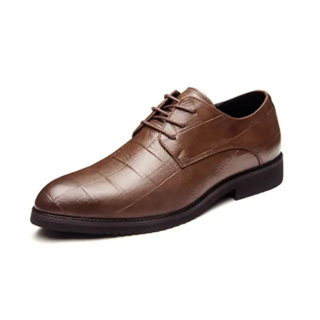 A brown leather men's dress shoe featuring a subtle crocodile skin texture, closed lacing system, and a low black rubber sole, displayed on a white background.