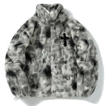 A plush zip-up fleece jacket in a gray and black mottled pattern, featuring a high stand collar, long sleeves, and side pockets. It has a soft fuzzy texture and a small dark graphic detail on the chest, giving it a cozy streetwear look.