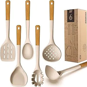Kitchen utensil set with white silicone tools and wooden handles—slotted turner, spoon, ladle, pasta server, skimmer, and spatula—displayed beside a box labeled “6.”