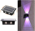 A solar-powered wall light with dual lights and solar panels, shown both in a close-up view with dimensions and installed on a wall emitting purple light beams.