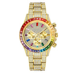 Gold-tone rhinestone-covered wristwatch with a multicolor gem bezel and matching jeweled bracelet band, featuring three subdials on the face.