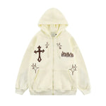 Cream zip-up hoodie with front pockets, cross graphic, and star-style printed details.