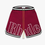 These Rhude shorts feature a bold and stylish design, perfect for streetwear and casual fashion. The elastic waistband with black-and-white stripe detailing and extra-long yellow drawstrings add a signature touch, making them both functional and fashionable. The sporty aesthetic is enhanced by the sleek trim along the hem, making them a great choice for everyday wear or athleisure outfits.