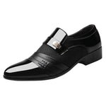 A black formal dress shoe with a glossy toe, brown strap detail, mesh side panels, and a low heel.