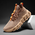 Beige knit lace-up trainers with a chunky hollow sole and orange heel tab detail.