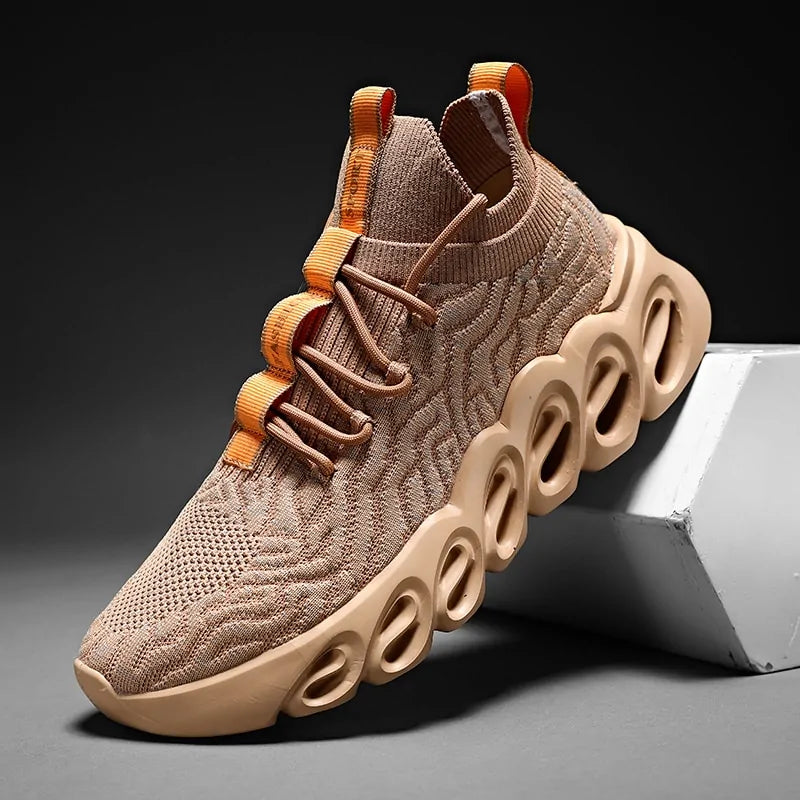 Beige knit lace-up trainers with a chunky hollow sole and orange heel tab detail.