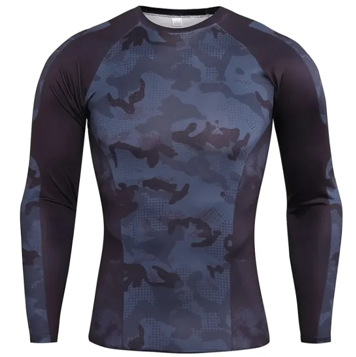 A long-sleeved athletic compression shirt with a gray, black, and white camouflage pattern on the front and sleeves. The shirt has black side panels and raglan-style sleeves, giving it a sporty and fitted design. The fabric appears to be stretchy and moisture-wicking, suitable for workouts or outdoor activities.