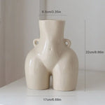 Cream abstract body-shaped vase with size measurements shown.