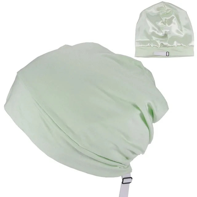 Light mint-green satin bonnet with an adjustable strap, shown on a white background with a small inset view of the bonnet from another angle.