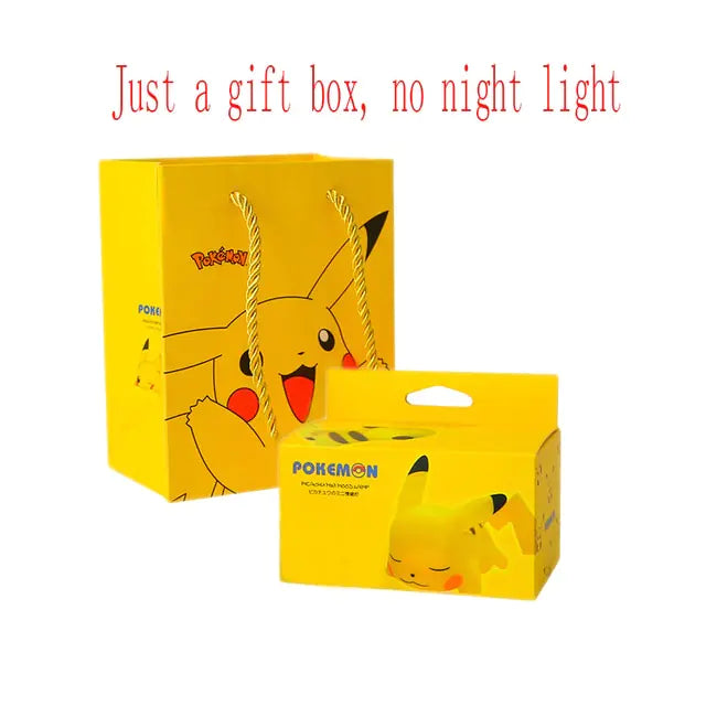 A Pikachu-themed gift box and packaging. The gift box is yellow with a smiling Pikachu illustration on it, and the text "Just a gift box, no night light" is written above. There is also a smaller gift box with Pikachu's face.