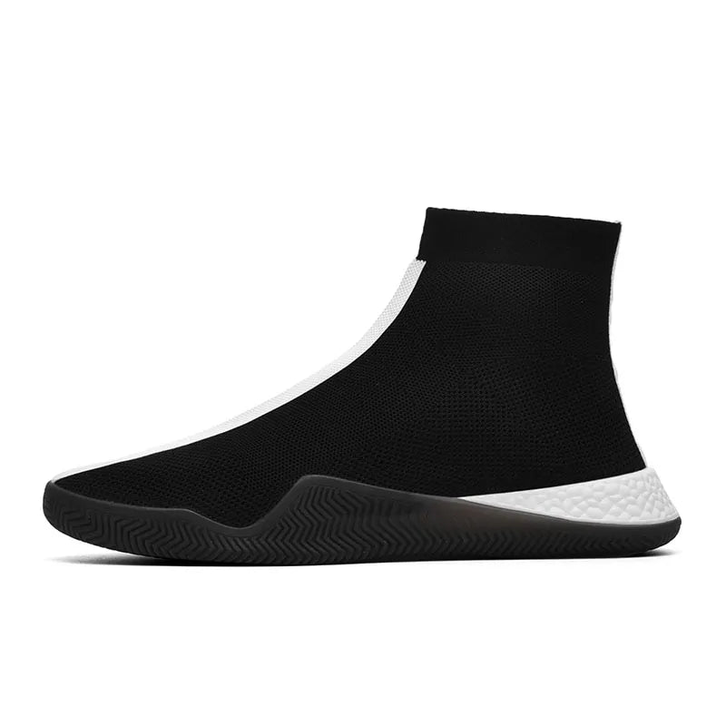 Black slip-on sock-style sneaker with a mid-top knit upper, black rubber outsole, and white textured heel section, shown in side view on a white background.