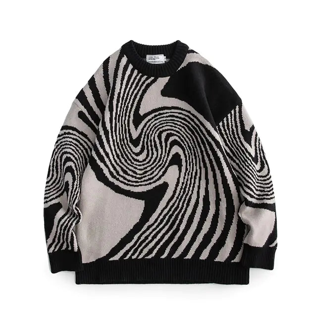 A studio product image of an oversized knit crewneck sweater on a white background, featuring a bold black, white, and gray abstract swirl/optical-illusion pattern with ribbed cuffs, collar, and hem.