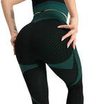 Woman wearing a seamless, textured long-sleeve athletic zip-up top in a light pink and peach gradient, featuring a high collar and thumb holes.