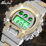Close-up of a silver and gold-tone digital wristwatch encrusted with rhinestones, featuring a green backlit display and three green circular accents above the screen; “Miss Fox” logo appears in the top-left corner.