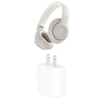 Beige Beats over-ear headphones floating above a white wall power adapter, shown on a white background.