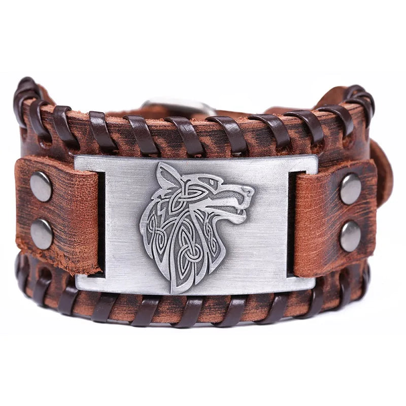 brown leather cuff bracelet featuring a silver Viking wolf head emblem in the center, surrounded by braided leather detailing and metal studs on each side.