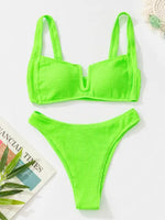Neon green textured bikini set with a scoop-style top, wide shoulder straps, a front U-wire detail, and matching high-cut bottoms.