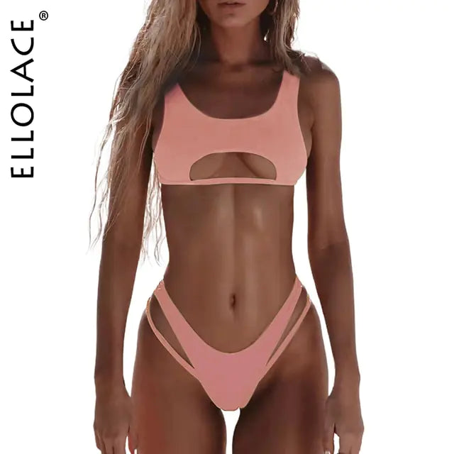 Woman standing on a beach wearing a brown two-piece bikini with a cutout detail on the top and high-cut bottoms with thin side straps, with “ELLOLACE” branding along the side.