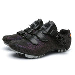 A pair of vibrant cycling shoes with a black and neon yellow camouflage pattern. The shoes feature a rugged sole with cleats, suitable for mountain biking or off-road cycling. They have two Velcro straps and a buckle fastening system for a secure fit. One shoe is placed upright while the other rests on its side, displaying the cleated sole.