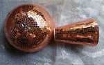Two rose-gold mosaic disco-ball pieces—one round and one tapered—lying on bubble wrap packaging.