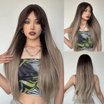 Long straight ombre wig with dark brown roots blending into ash blonde lengths, shown on a model from front, side, and back views, featuring a natural centre part and sleek finish.