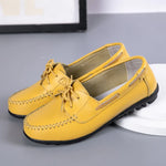 Yellow lace-up driving loafers with contrast sole.
