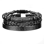 Stack of three black men’s bracelets, including a Roman numeral bangle and two braided/beaded leather-style bands.