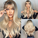 Long wavy blonde wig with darker roots and full fringe, shown on a model from front and back views, featuring soft layers, natural volume, and a smooth blended finish.